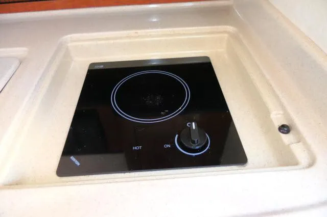 Slide: The Image of 2005 Sea Ray 280 Sundancer stove with black glass cooktop and control knob. - 16