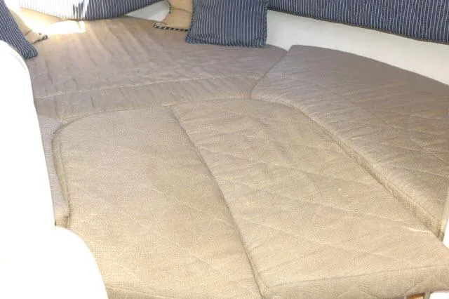 Slide: The Image of 2005 Sea Ray 280 Sundancer cabin interior with beige cushioned seating and striped pillows. - 20