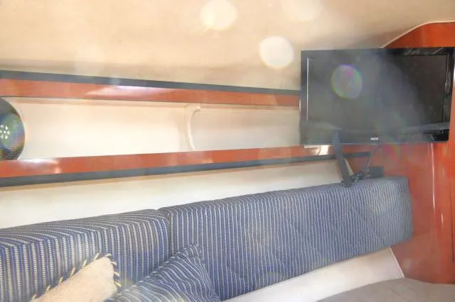 Slide: The Image of Interior of 2005 Sea Ray 280 Sundancer with TV and striped seating. - 22