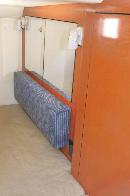 Slide: The Image of Interior cabin of 2005 Sea Ray 280 Sundancer with wood paneling and striped cushion. - 23