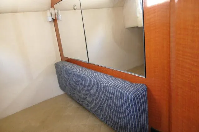 Slide: The Image of Interior cabin of 2005 Sea Ray 280 Sundancer with mirror and cushioned seating. - 24