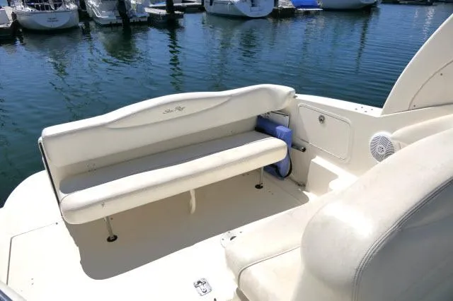 Slide: The Image of 2005 Sea Ray 280 Sundancer boat interior with white seating, docked at marina. - 31