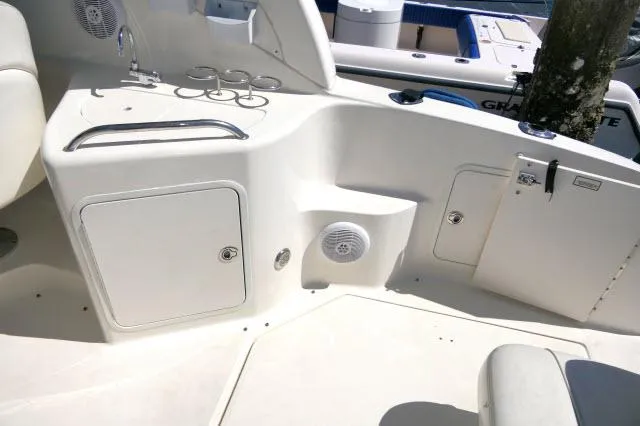 Slide: The Image of 2005 Sea Ray 280 Sundancer boat interior with storage compartments and cup holders. - 33