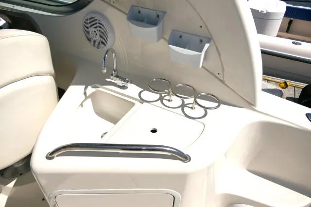 Slide: The Image of 2005 Sea Ray 280 Sundancer boat interior with sink and cup holders. - 34