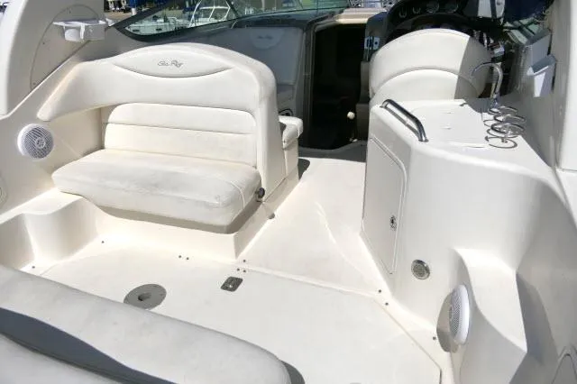 Slide: The Image of 2005 Sea Ray 280 Sundancer boat interior with white seating and dashboard. - 35