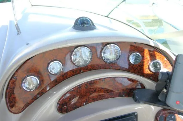 Slide: The Image of Dashboard of 2005 Sea Ray 280 Sundancer with wood finish and gauges. - 39