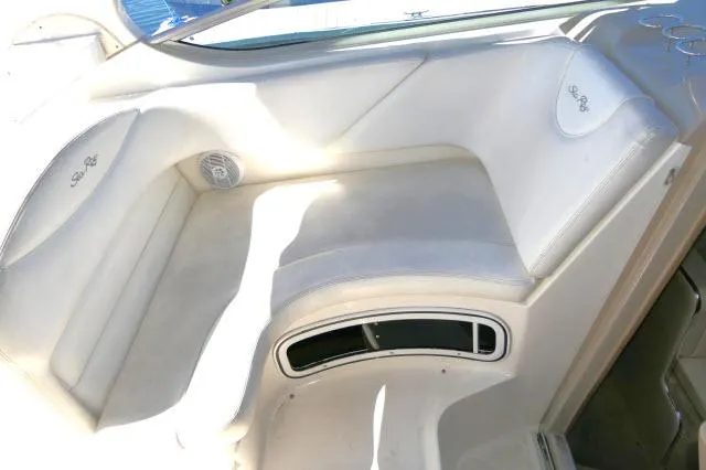 Slide: The Image of 2005 Sea Ray 280 Sundancer interior seating with white upholstery and speaker detail. - 41