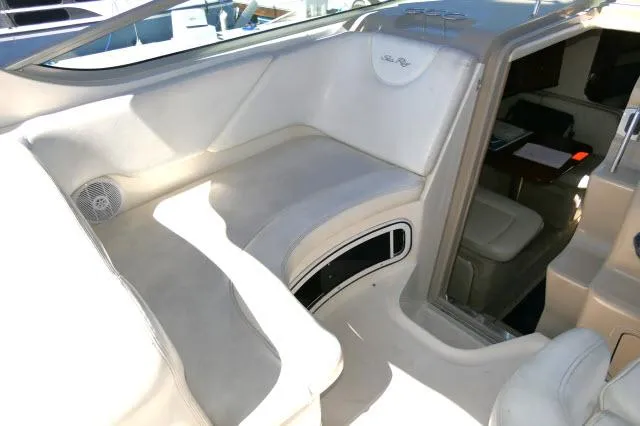 Slide: The Image of 2005 Sea Ray 280 Sundancer interior with white seating and cabin entrance. - 42