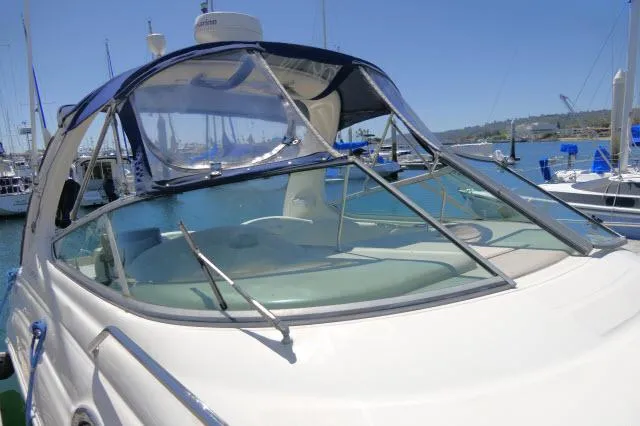 Slide: The Image of 2005 Sea Ray 280 Sundancer boat docked in a marina under clear blue skies. - 47