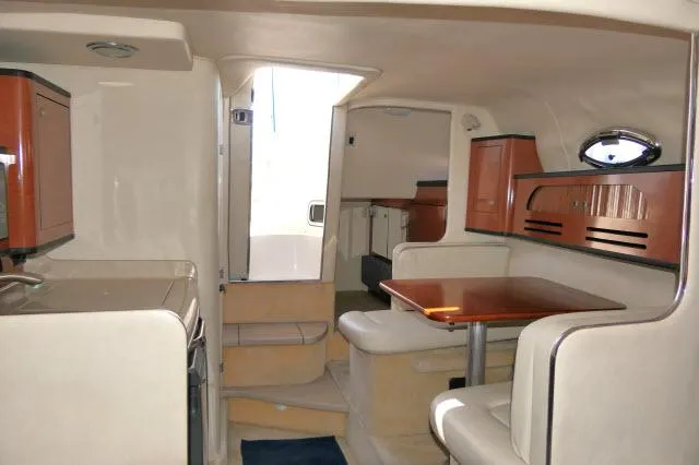 Slide: The Image of Interior of 2005 Sea Ray 280 Sundancer boat with dining area and cabinetry. - 7