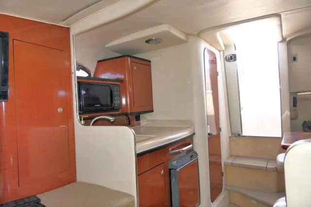 Slide: The Image of Interior of 2005 Sea Ray 280 Sundancer boat with kitchenette and stairs. - 9