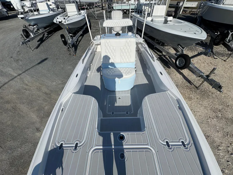 Slide: The Image of 2025 Contender 23 Bay boat interior with seating and storage compartments. - 10