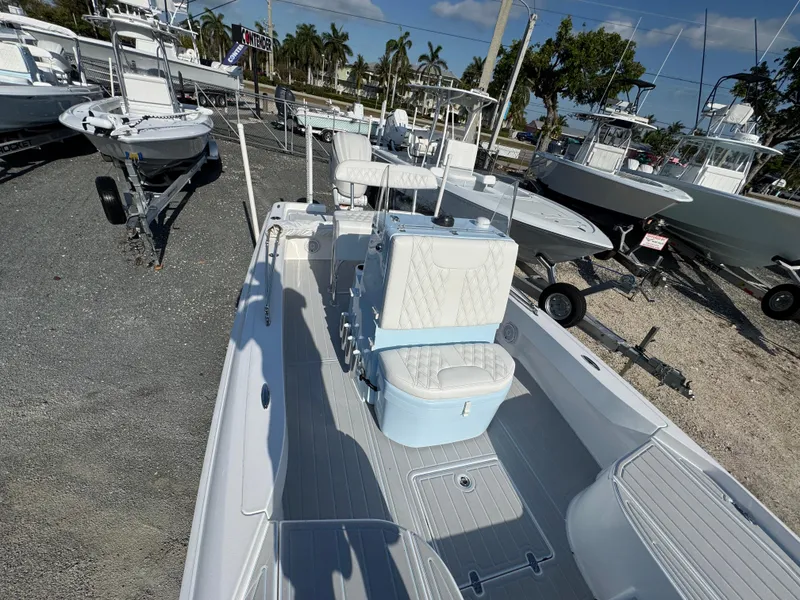 Slide: The Image of 2025 Contender 23 Bay boat with sleek design, docked outdoors under clear skies. - 11