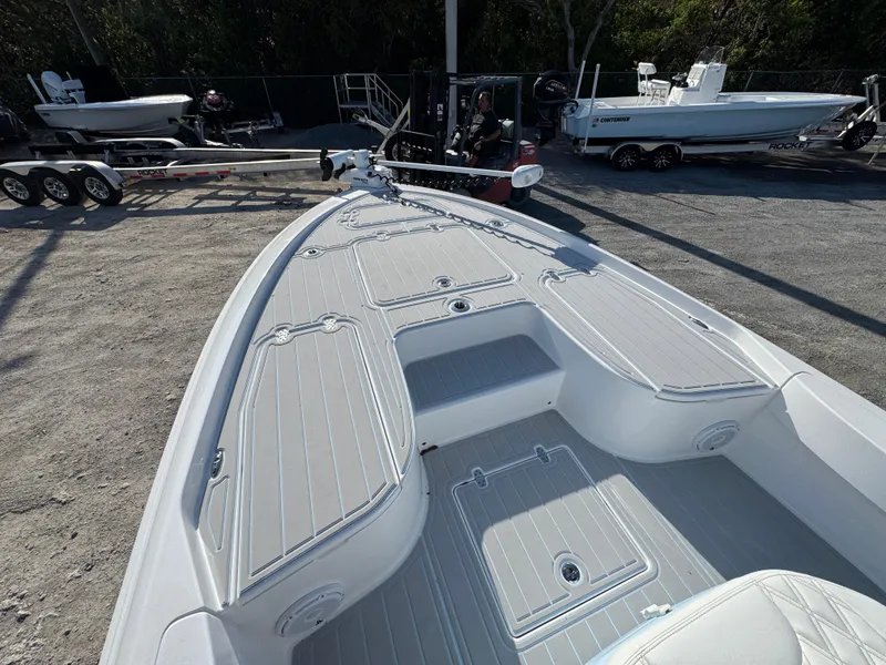 Slide: The Image of 2025 Contender 23 Bay boat deck with storage compartments and seating. - 7