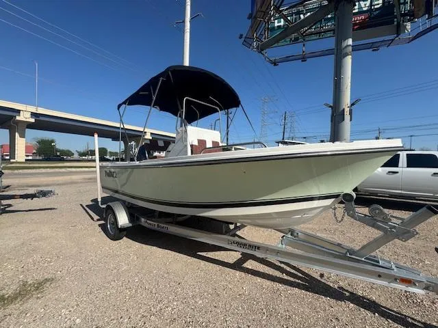 The Image of 2025 Parker 18SE Center Console boat on trailer, parked outdoors under a clear sky. - 0