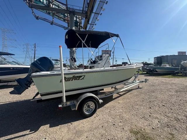 Slide: The Image of 2025 Parker 18SE Center Console boat on trailer, outdoor display, sunny day. - 1