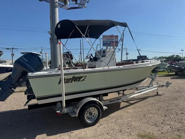 Slide: The Image of 2025 Parker 18SE Center Console boat on trailer with canopy, displayed outdoors. - 2