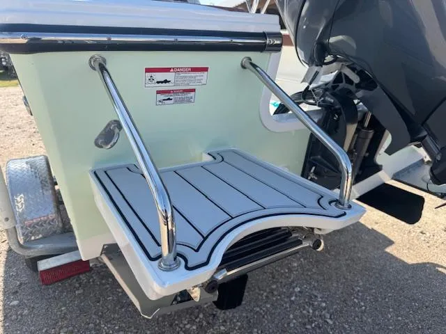 Slide: The Image of 2025 Parker 18SE Center Console boat swim platform with stainless steel rails. - 5