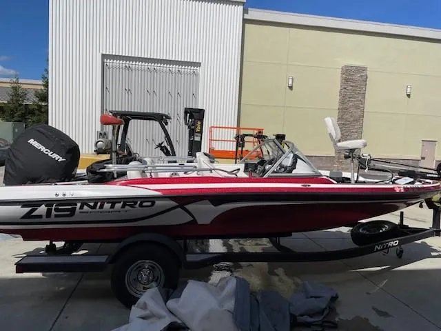 Slide: The Image of 2020 Nitro Z19 Sport boat with Mercury engine, parked outdoors on a trailer. - 0