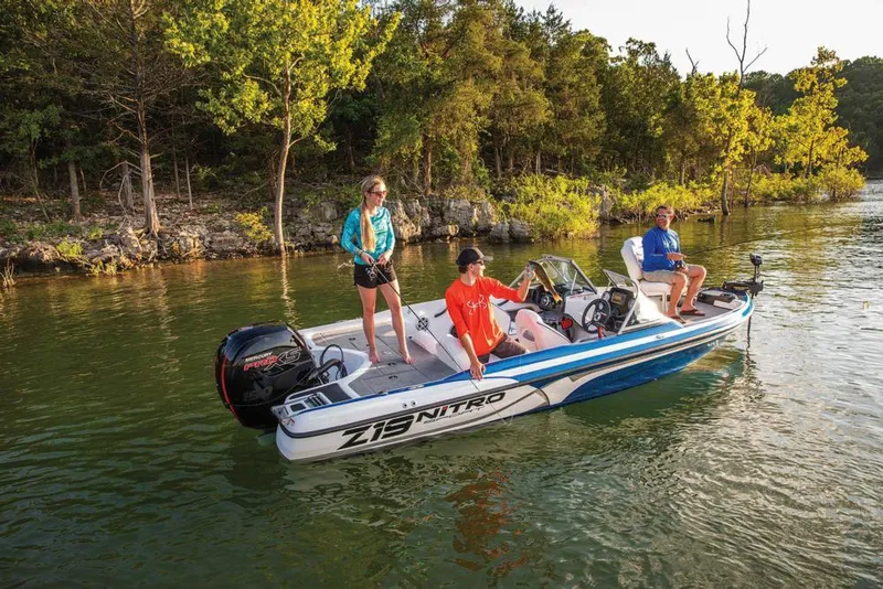 Slide: The Image of 2020 Nitro Z19 Sport boat on a lake with three people enjoying a sunny day. - 16