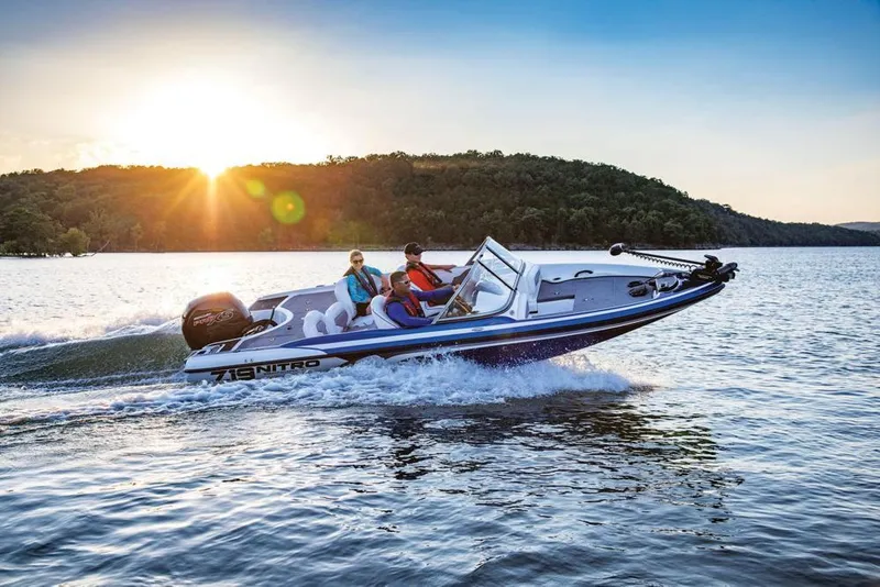 Slide: The Image of 2020 Nitro Z19 Sport boat cruising on a lake at sunset. - 20