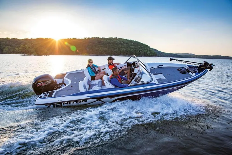 Slide: The Image of 2020 Nitro Z19 Sport boat cruising on a lake at sunset with passengers. - 21