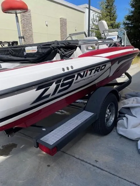 Slide: The Image of 2020 Nitro Z19 Sport boat on trailer, red and white design, parked outdoors. - 4