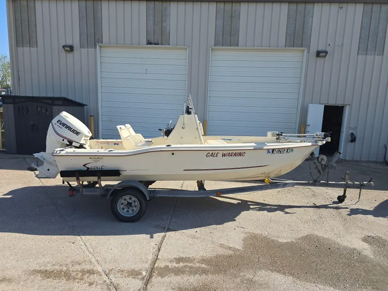 Slide: The Image of 1993 Scout 172 Sportfish boat on trailer, parked outside a building. - 3