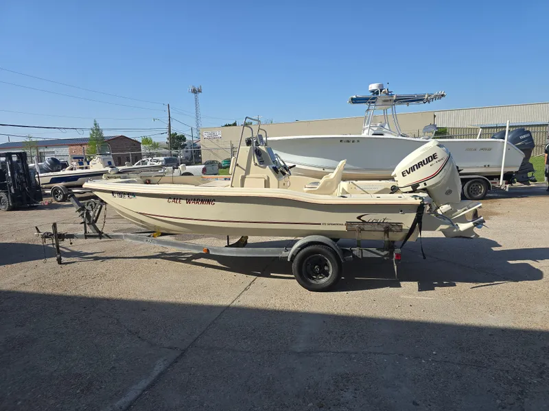 Slide: The Image of 1993 Scout 172 Sportfish boat with Evinrude motor on trailer, parked outdoors. - 7