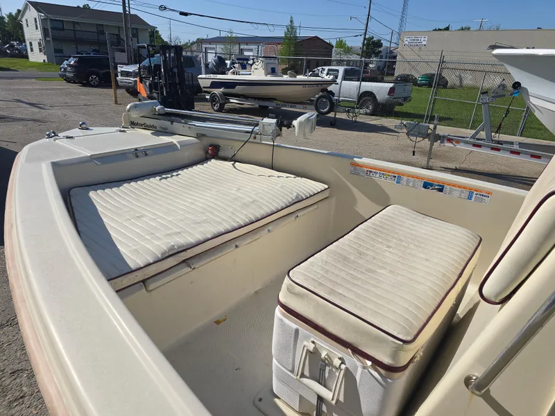 Slide: The Image of 1993 Scout 172 Sportfish boat interior with cushioned seating and fishing equipment. - 9