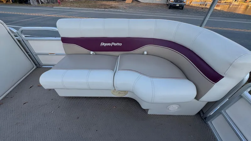 Slide: The Image of 2005 AquaPatio Cruise boat seating with white and purple upholstery. - 2
