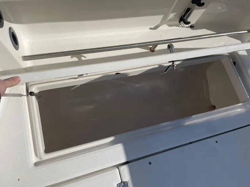 Slide: The Image of Open storage compartment on a 2009 Robalo R305 Walkaround boat. - 11