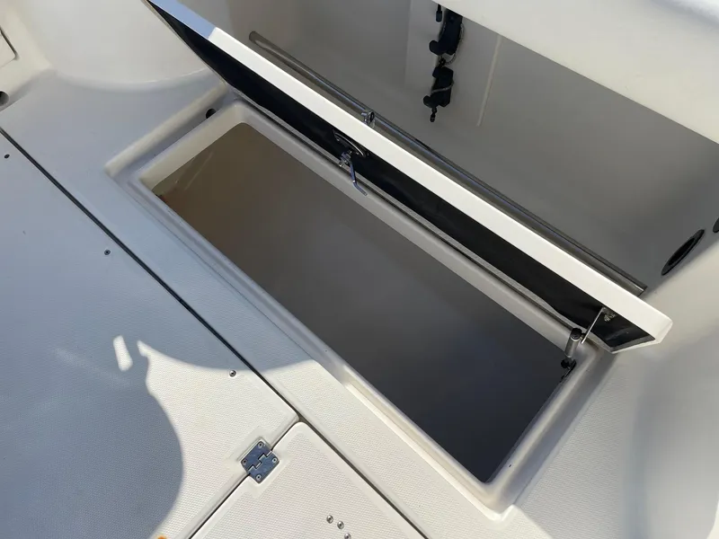 Slide: The Image of Open storage compartment on 2009 Robalo R305 Walkaround boat deck. - 12