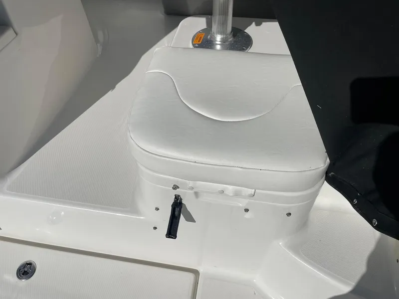 Slide: The Image of 2009 Robalo R305 Walkaround boat seat with white upholstery and metal support. - 14