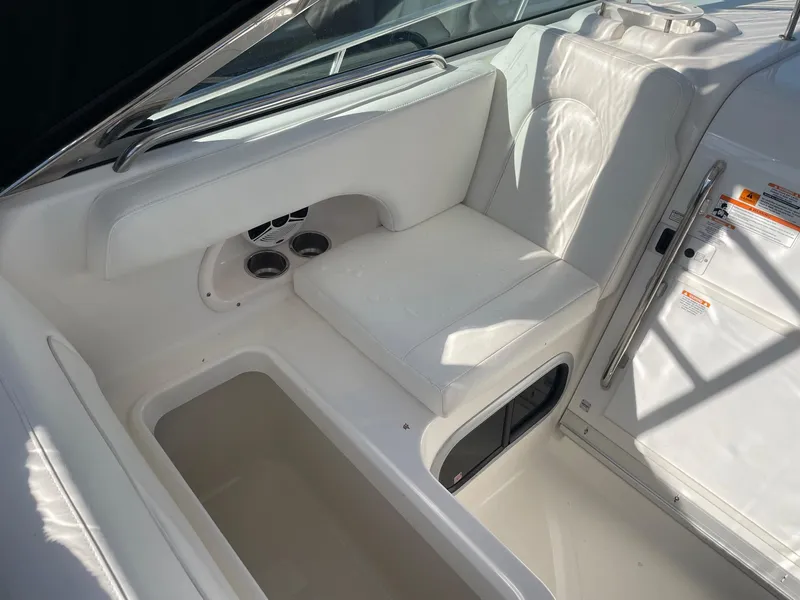 Slide: The Image of 2009 Robalo R305 Walkaround interior with white seating and storage compartments. - 19