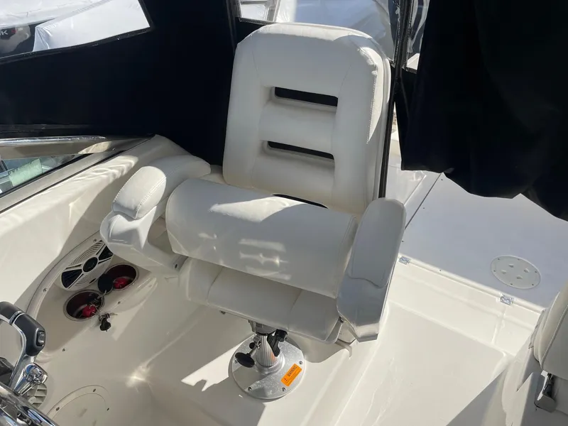 Slide: The Image of 2009 Robalo R305 Walkaround boat interior with white captain's chair. - 20