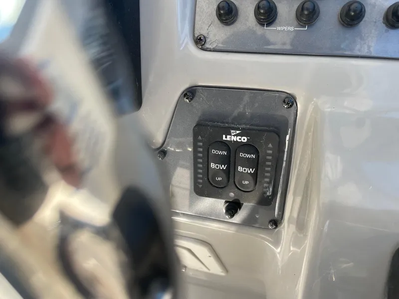Slide: The Image of Control panel of a 2009 Robalo R305 Walkaround boat with Lenco trim tab switches. - 24