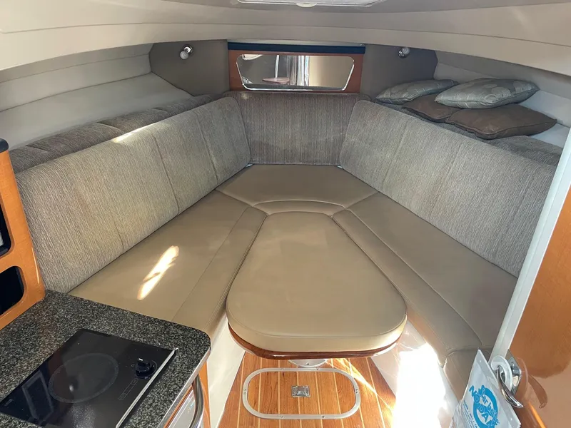 Slide: The Image of 2009 Robalo R305 Walkaround cabin interior with cozy seating and modern amenities. - 29