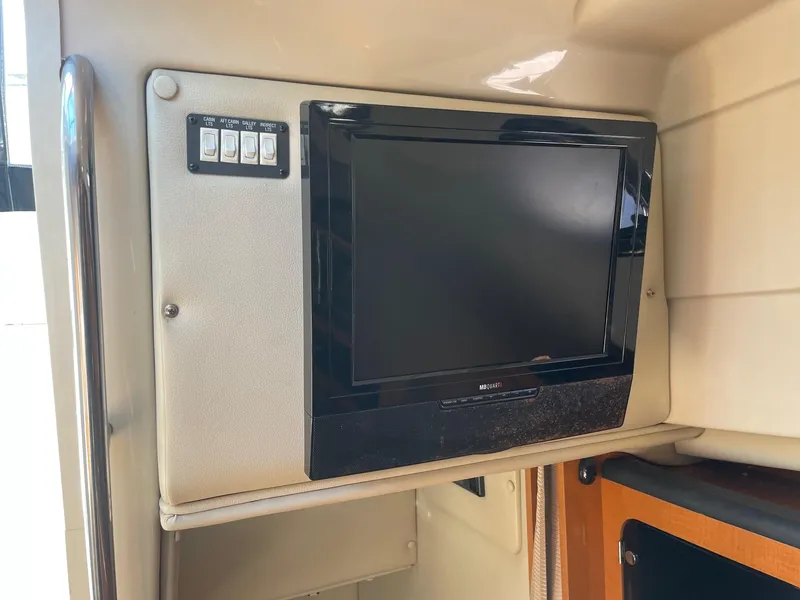 Slide: The Image of 2009 Robalo R305 Walkaround cabin interior with built-in TV and control panel. - 34