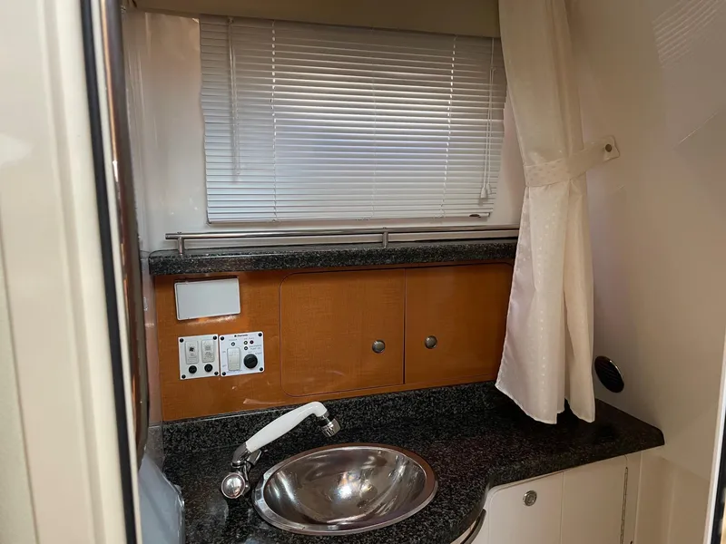 Slide: The Image of 2009 Robalo R305 Walkaround cabin interior with sink, countertop, and storage cabinets. - 37