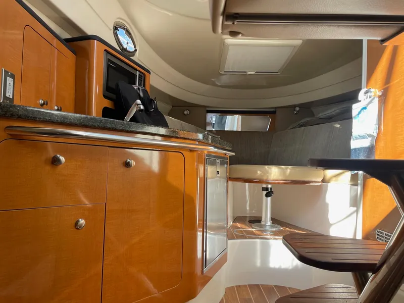 Slide: The Image of 2009 Robalo R305 Walkaround cabin interior with wood cabinetry and seating area. - 40