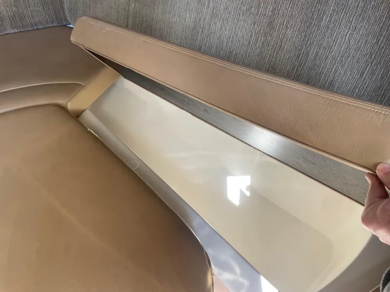 Slide: The Image of 2009 Robalo R305 Walkaround interior storage compartment with beige upholstery. - 43
