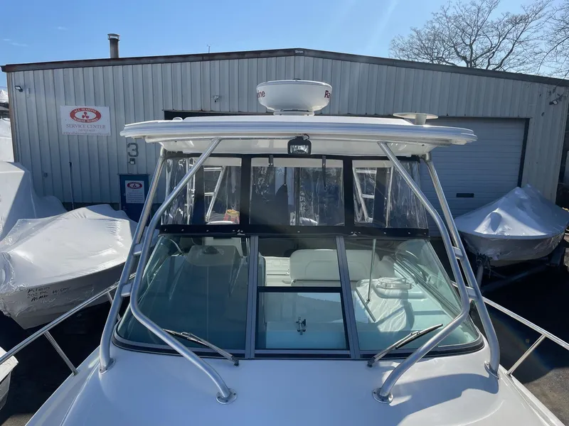 Slide: The Image of 2009 Robalo R305 Walkaround boat docked near a storage facility. - 49