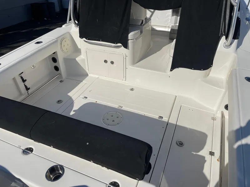 Slide: The Image of 2009 Robalo R305 Walkaround boat deck with seating and storage compartments. - 5