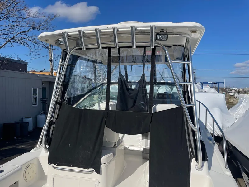 Slide: The Image of 2009 Robalo R305 Walkaround boat with covered cockpit and stainless steel frame. - 6