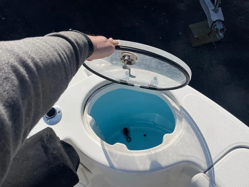 Slide: The Image of 2009 Robalo R305 Walkaround livewell with open lid, showcasing interior. - 8
