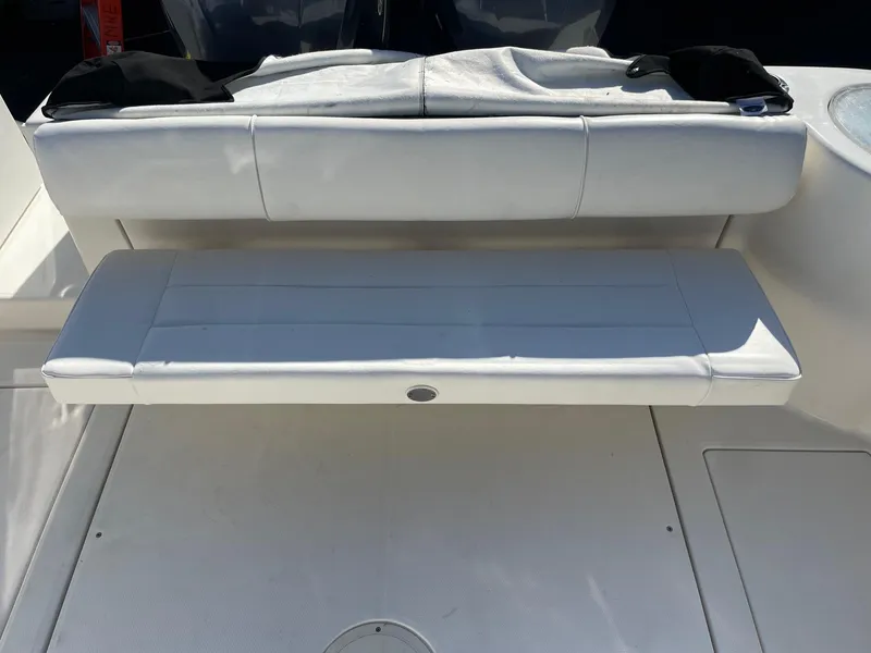 Slide: The Image of 2009 Robalo R305 Walkaround boat with white cushioned seating. - 9