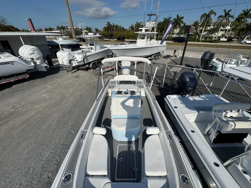 Slide: The Image of 2024 Contender 26 Bay boat displayed in a marina with other vessels. - 15