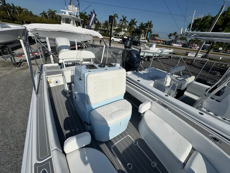 Slide: The Image of 2024 Contender 26 Bay boat with sleek interior and modern design, docked outdoors. - 16