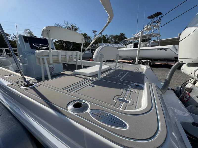 Slide: The Image of 2024 Contender 26 Bay boat deck with seating and fishing rod holders. - 8